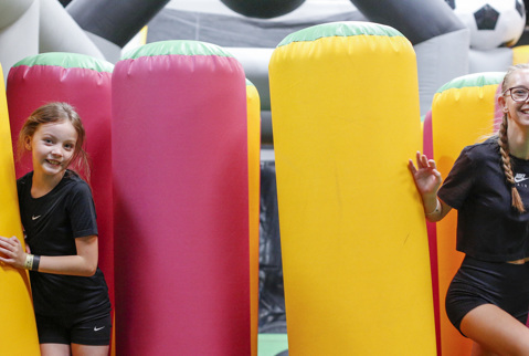 Girls having fun on the giant inflatable at Flip Out Rochdale