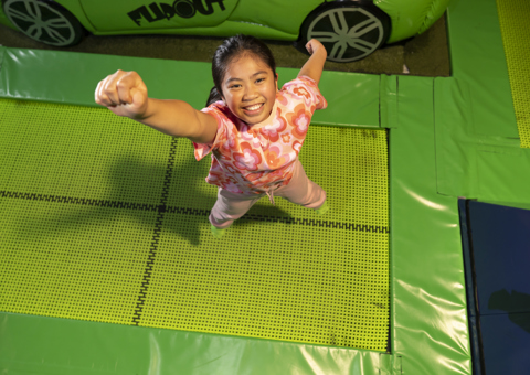A child posing on the Trampolines at Flip Out UK