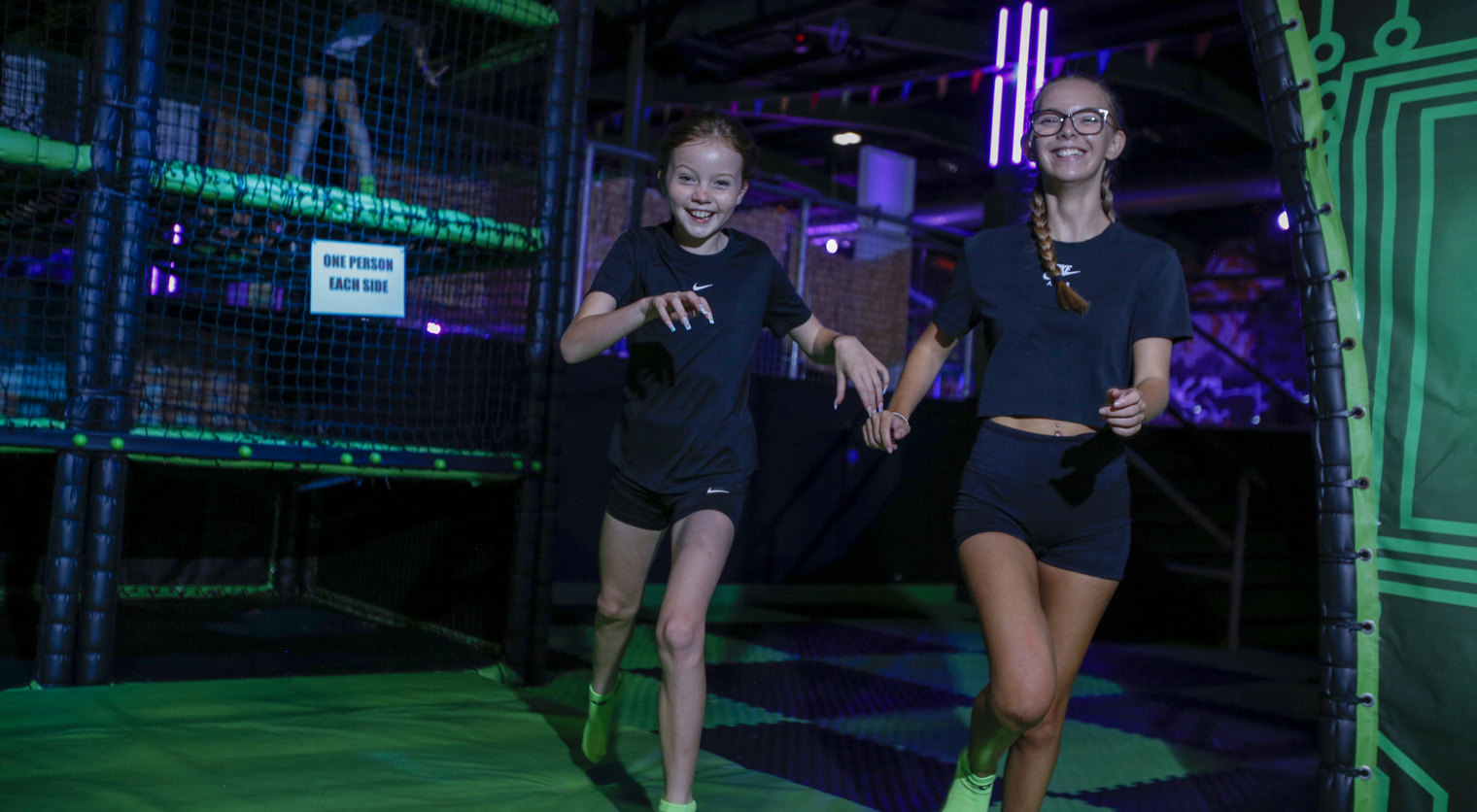 Girls playing Floor Is Fire at Flip Out UK