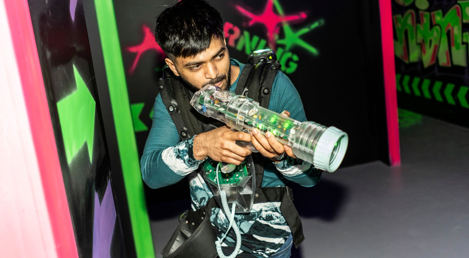 A man taking aim in the Laser Quest arena at Flip Out UK