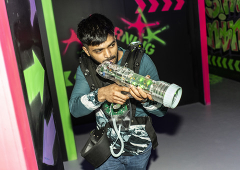 A man taking aim in the Laser Quest arena at Flip Out UK