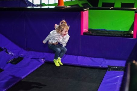 A small child bouncing in the Kids Stunt Zone at Flip Out UK