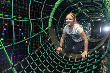 A child crawling through the Ninja Tag arena at Flip Out UK
