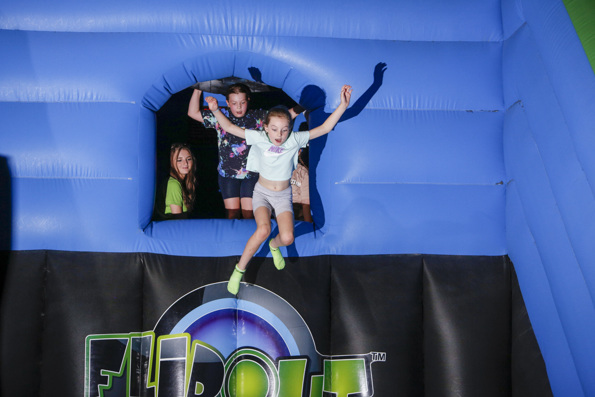 A child leaping into Free Fall on an inflatable at Flip Out UK