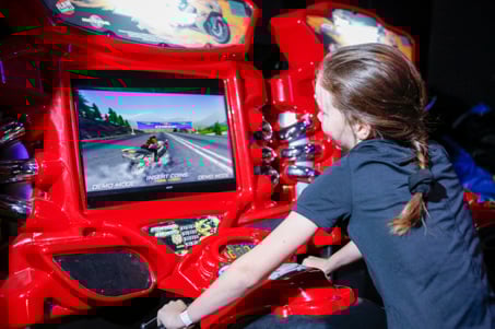 Girl playing arcade game at Flip Out UK
