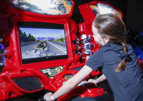 Girl playing arcade game at Flip Out UK