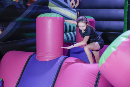 Children playing on an Inflatable Obstacle Course at Flip Out UK